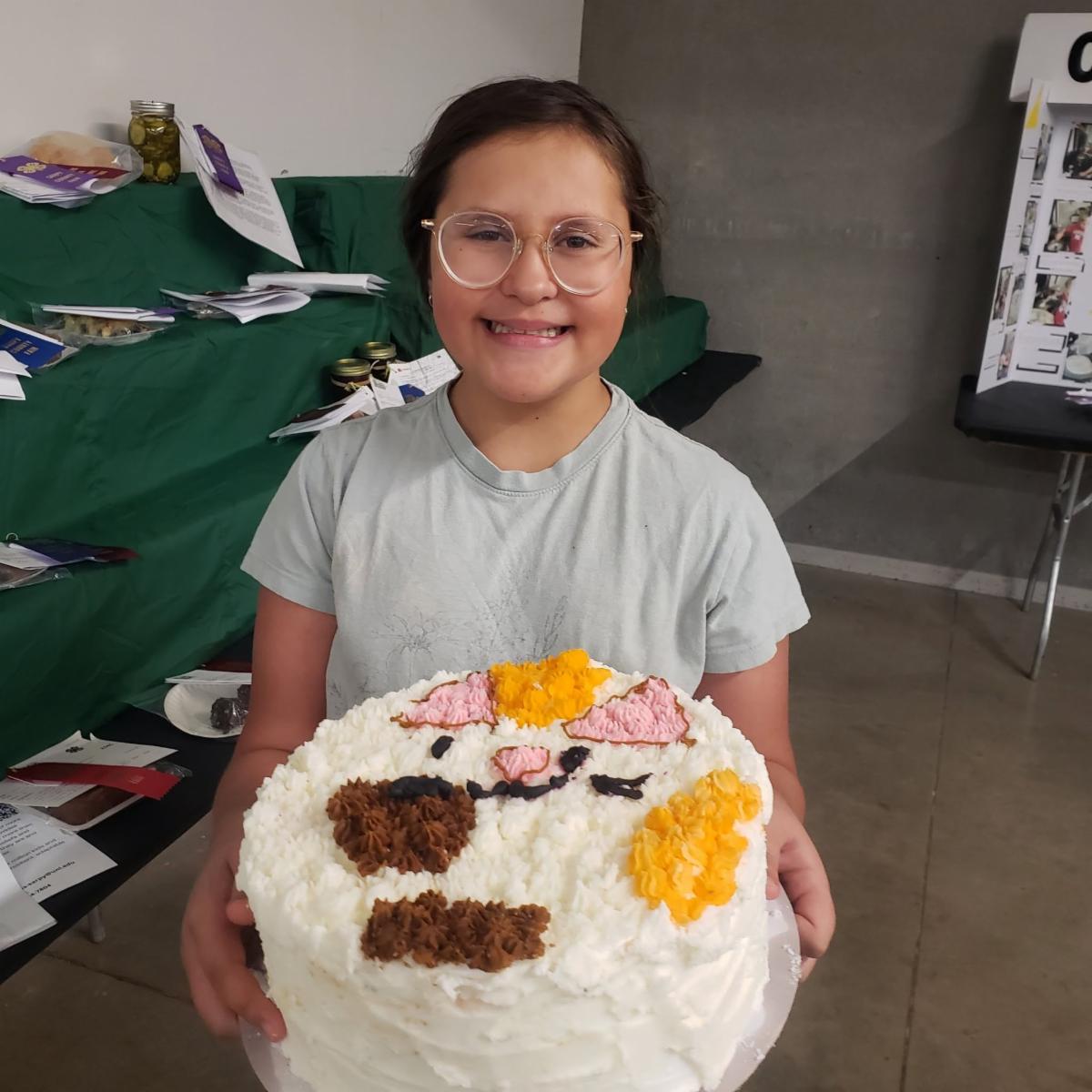 girl holding a decorated cake of a bunny
