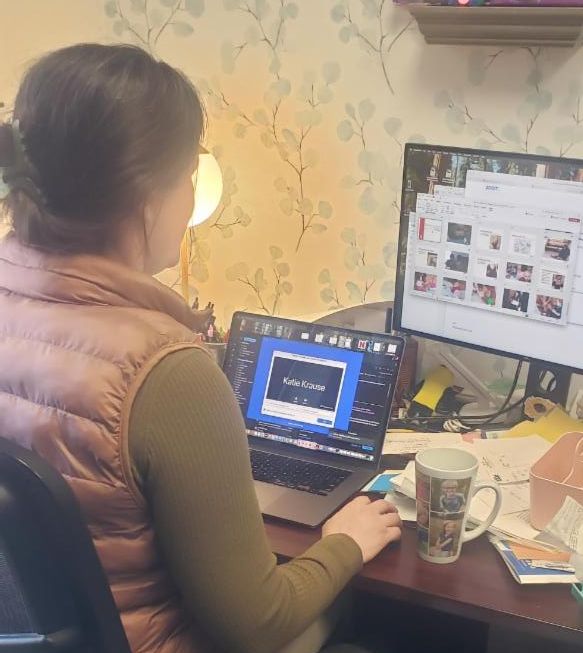 woman sitting at a computer in an office 