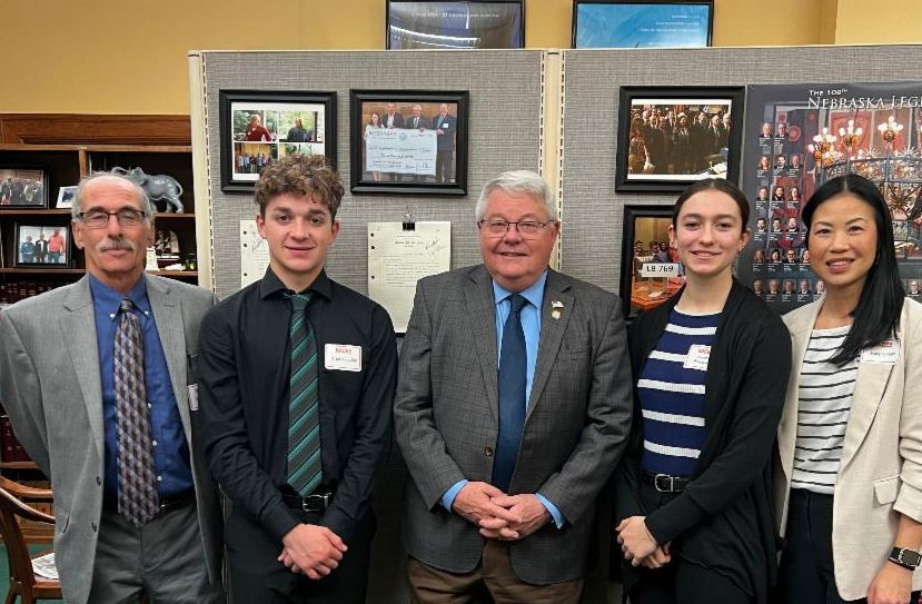 five people in formal attire standing side by side