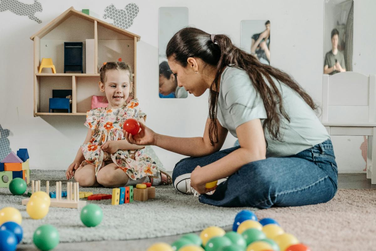 child playing with an adult on the floor 