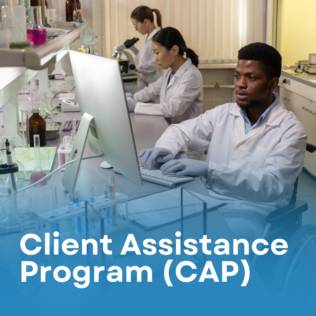 Black man wheelchair user typing on his computer at his job in a science laboratory. Text reads: Client Assistance Program.
