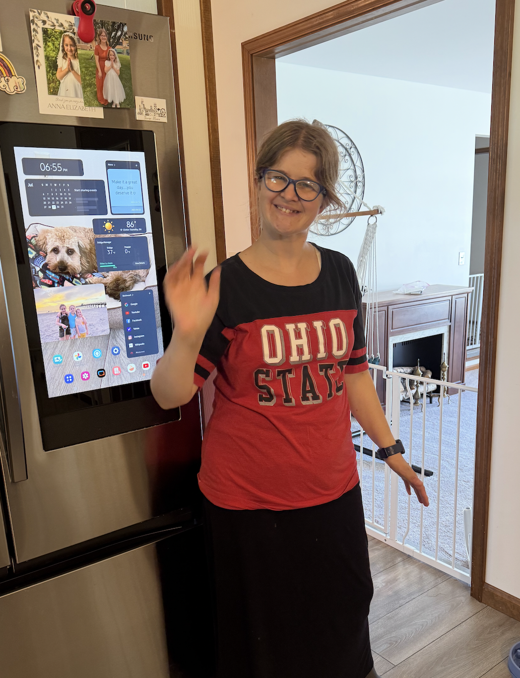 Jocelyn wearing an Ohio State shirt in front of her smart fridge