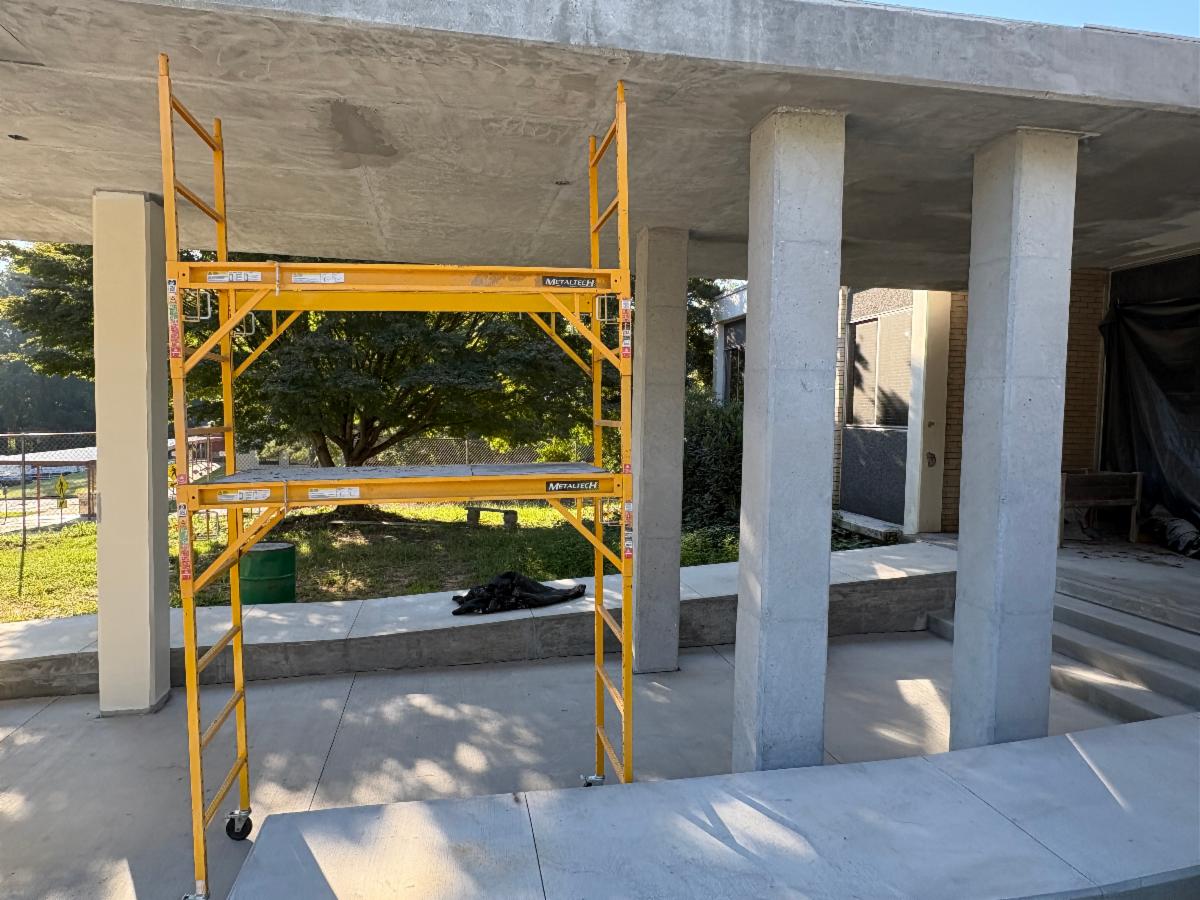 Contractors work on the exterior cement columns at the Shelnutt Senior Center 