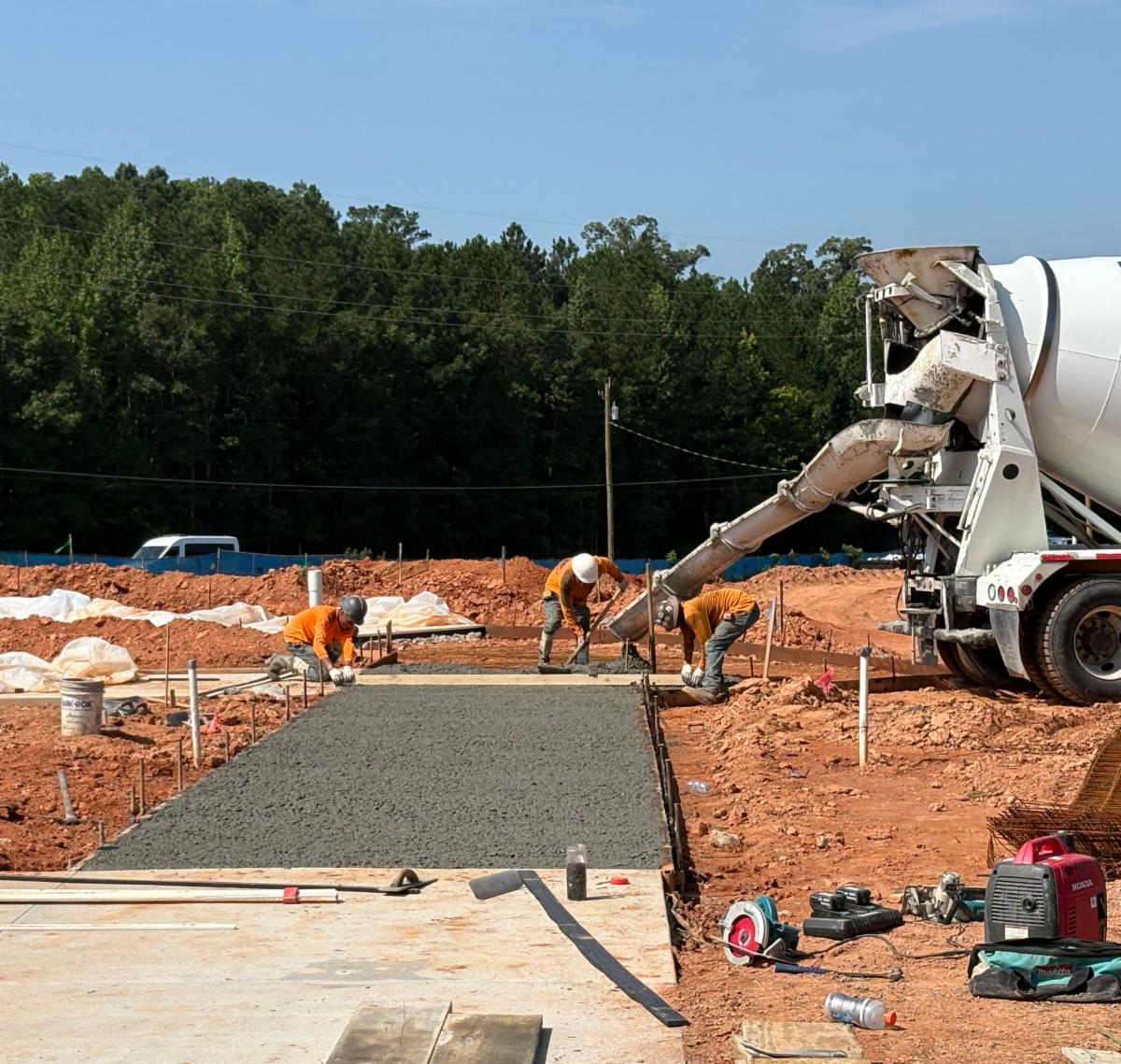 Contractors are pouring cement to create the sidewalks around the new Clayton County Administration Building site.