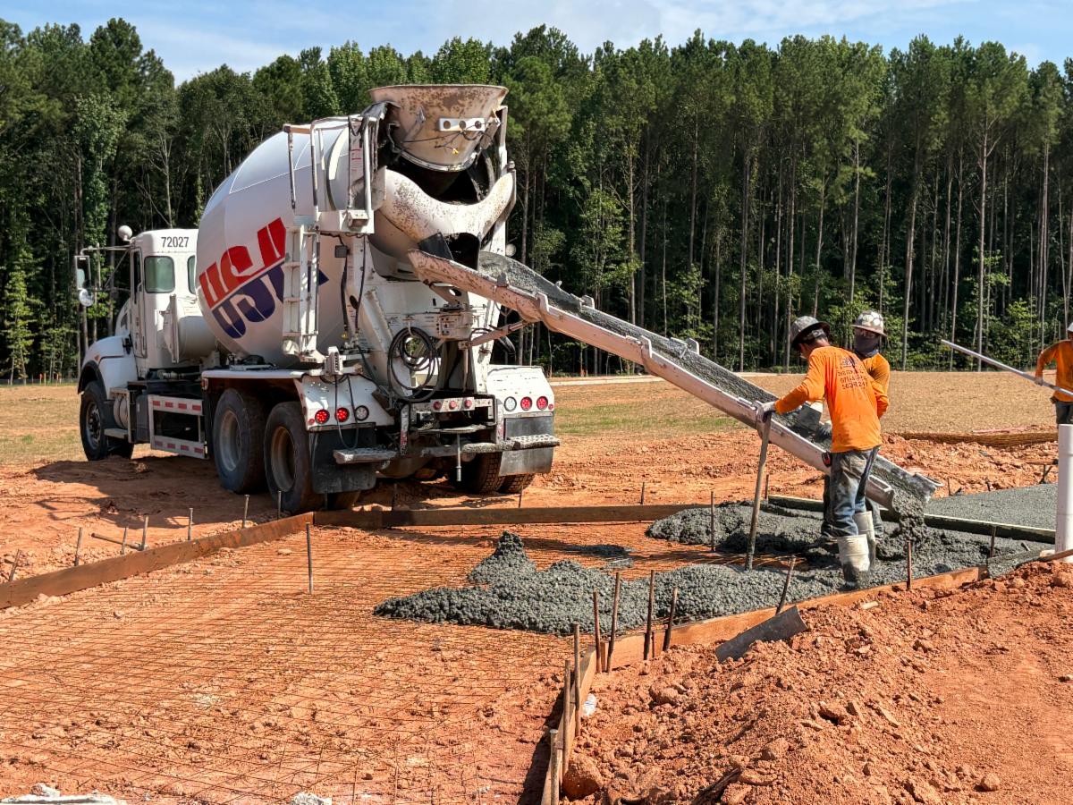 Contractors are pouring cement to create the sidewalks around the new Clayton County Administration Building site.