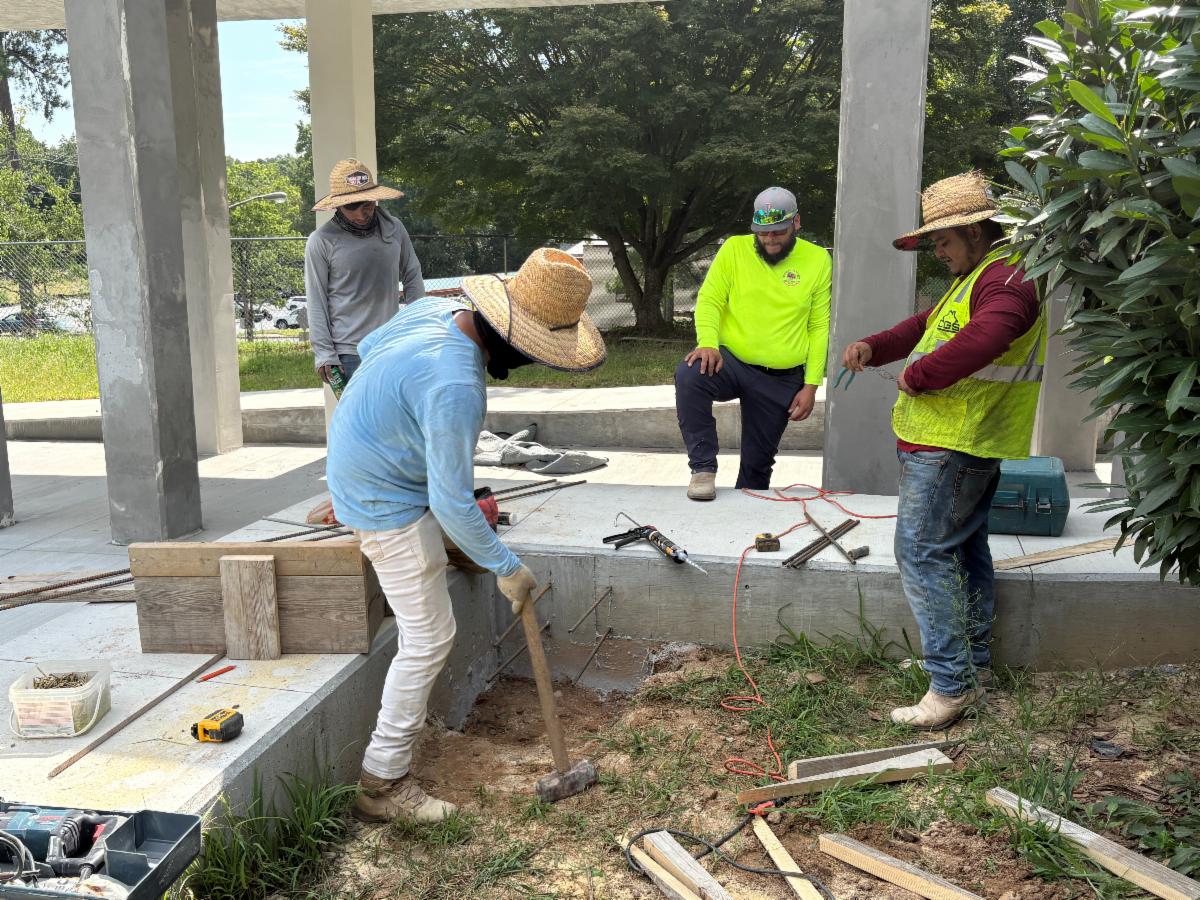 Contractors work on the exterior cement columns at the Shelnutt Senior Center 