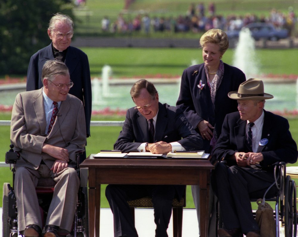 President George H. Bush signing the ADA on the White House South Lawn.
