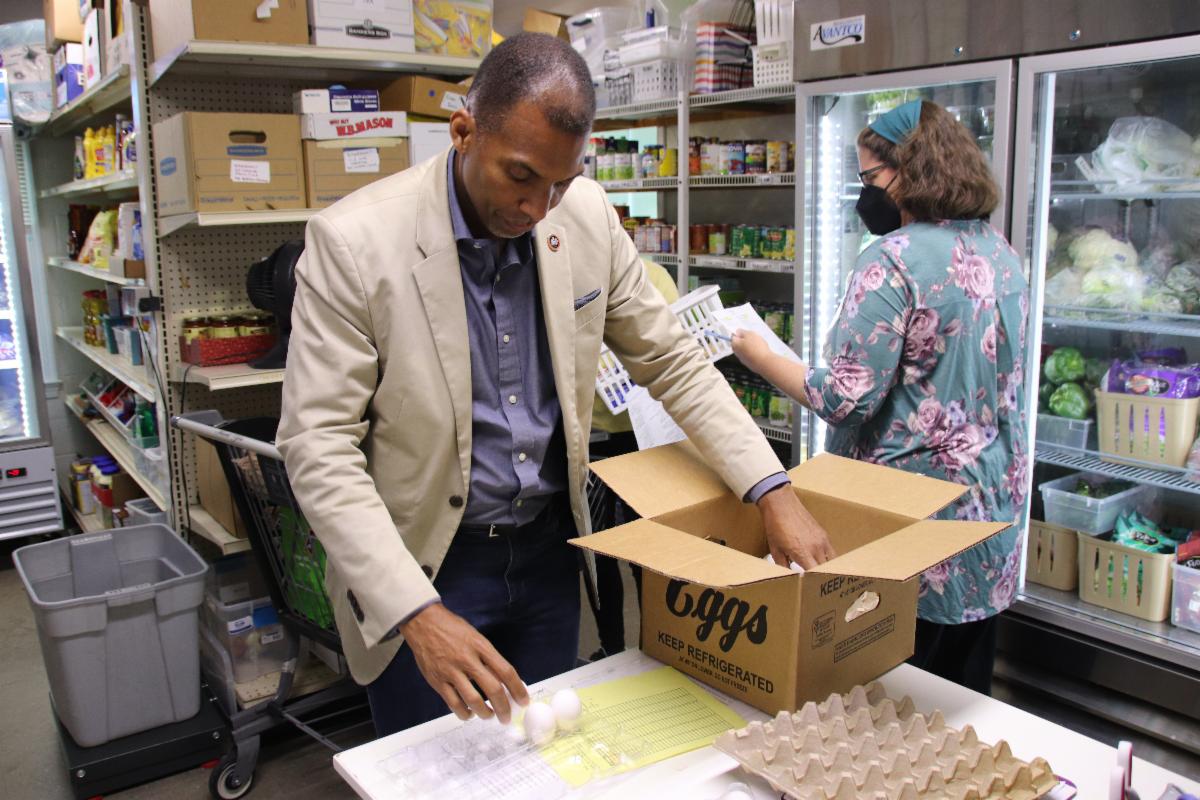 Man moves eggs from box.
