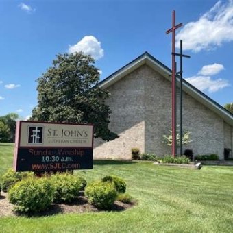 Church building with crosses in front of it.