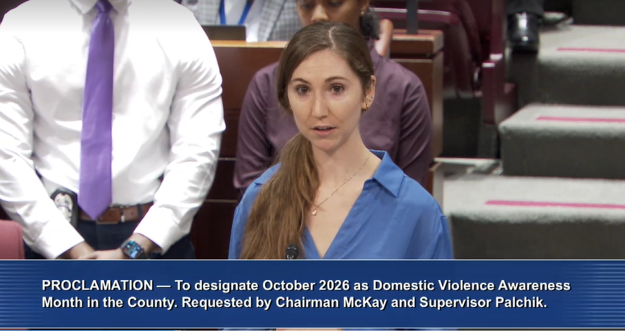 Woman speaks at podium.