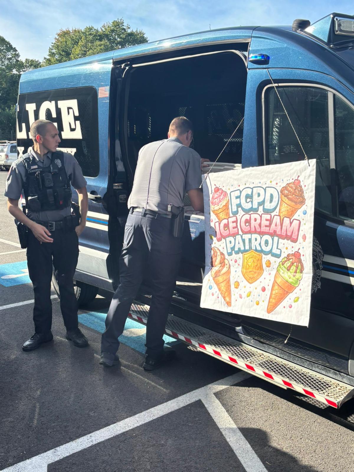 Police take ice cream out of a van. 