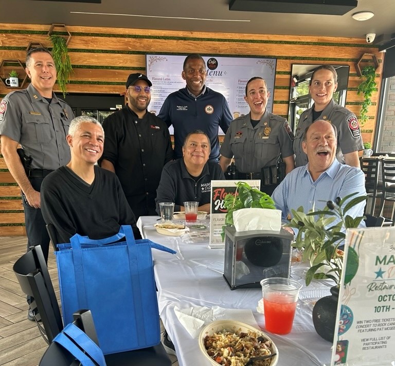 Group poses around table. 