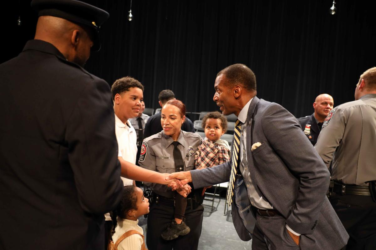 Man shakes hands with boy.