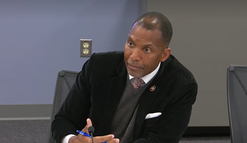Man speaking in front of microphone.