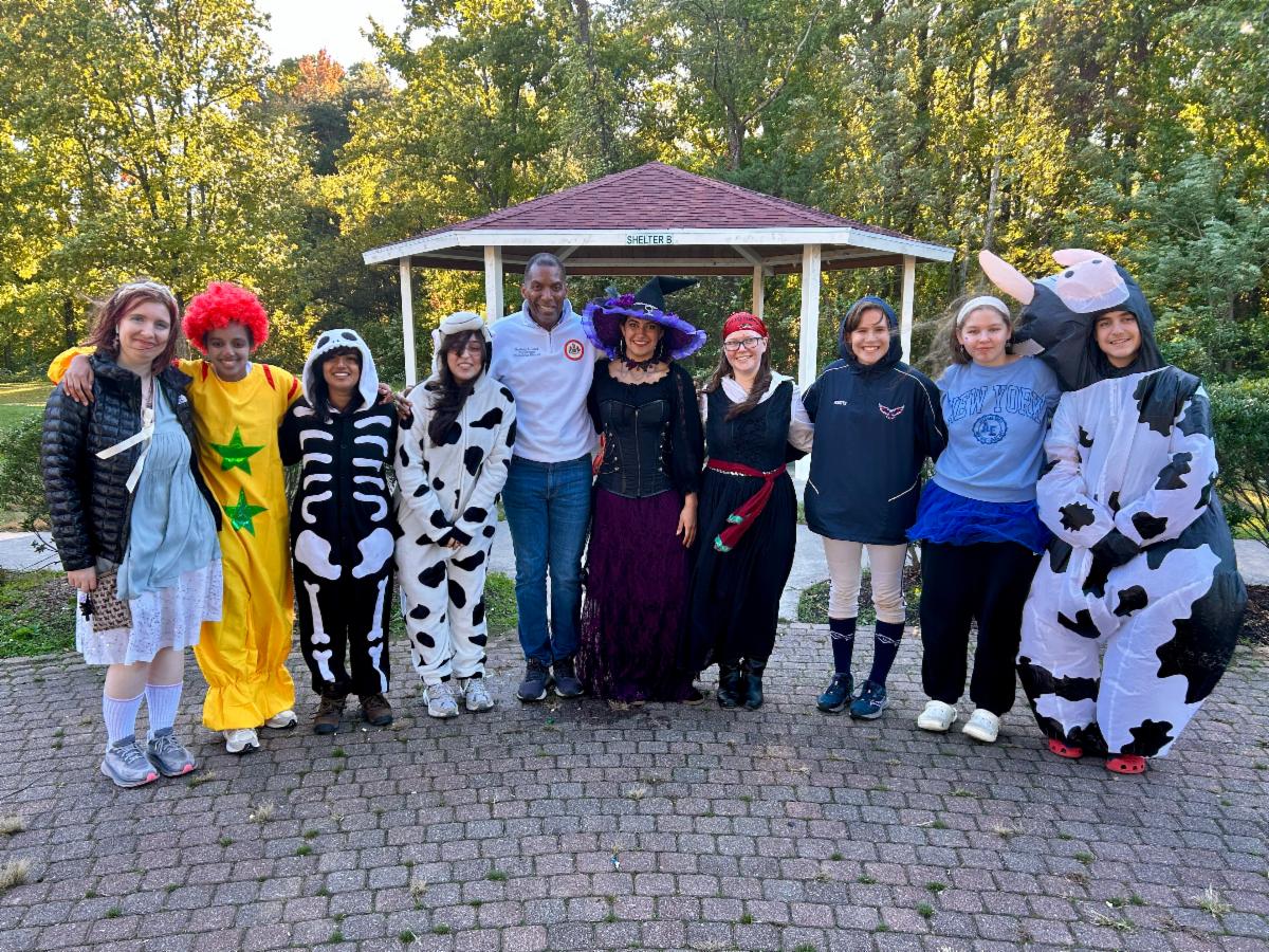 Group poses in Halloween costumes.