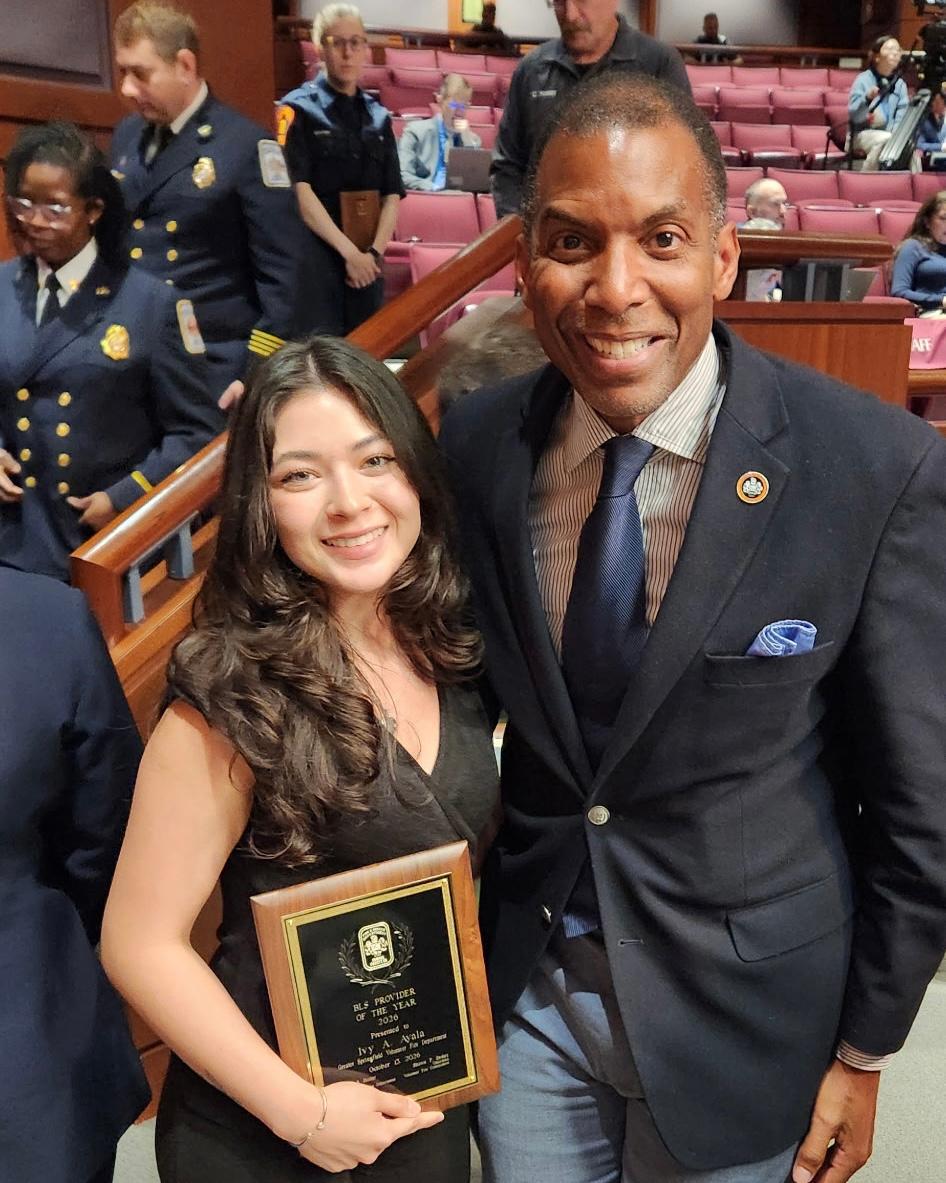 Man and woman pose holding plaque.