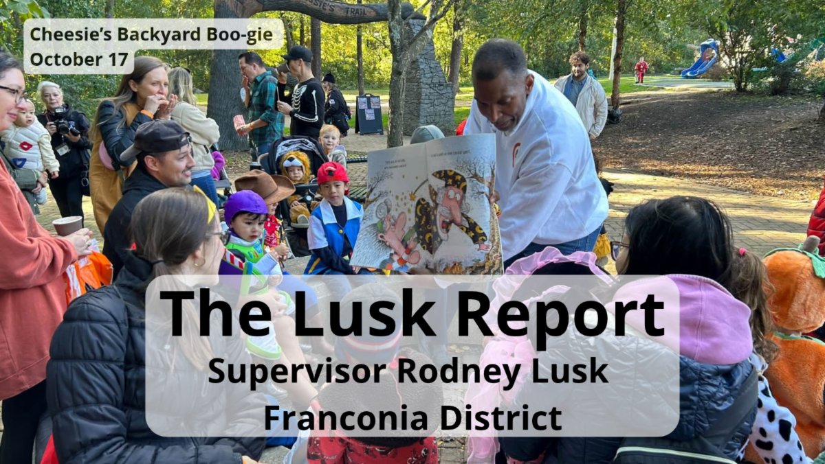 Man reads book to group of children.