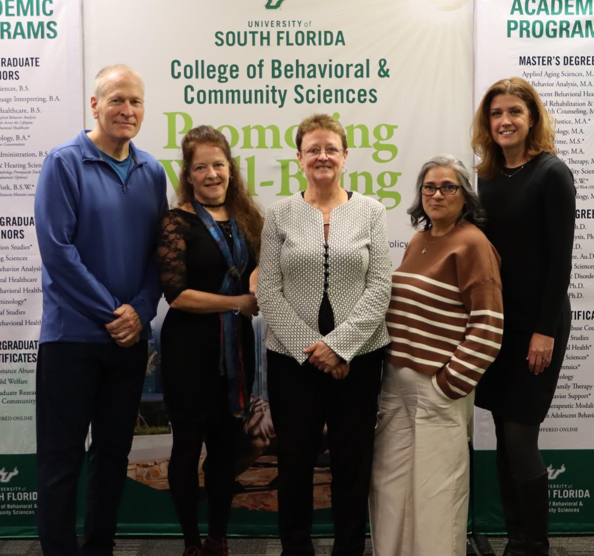 Photo of employees with the dean of college