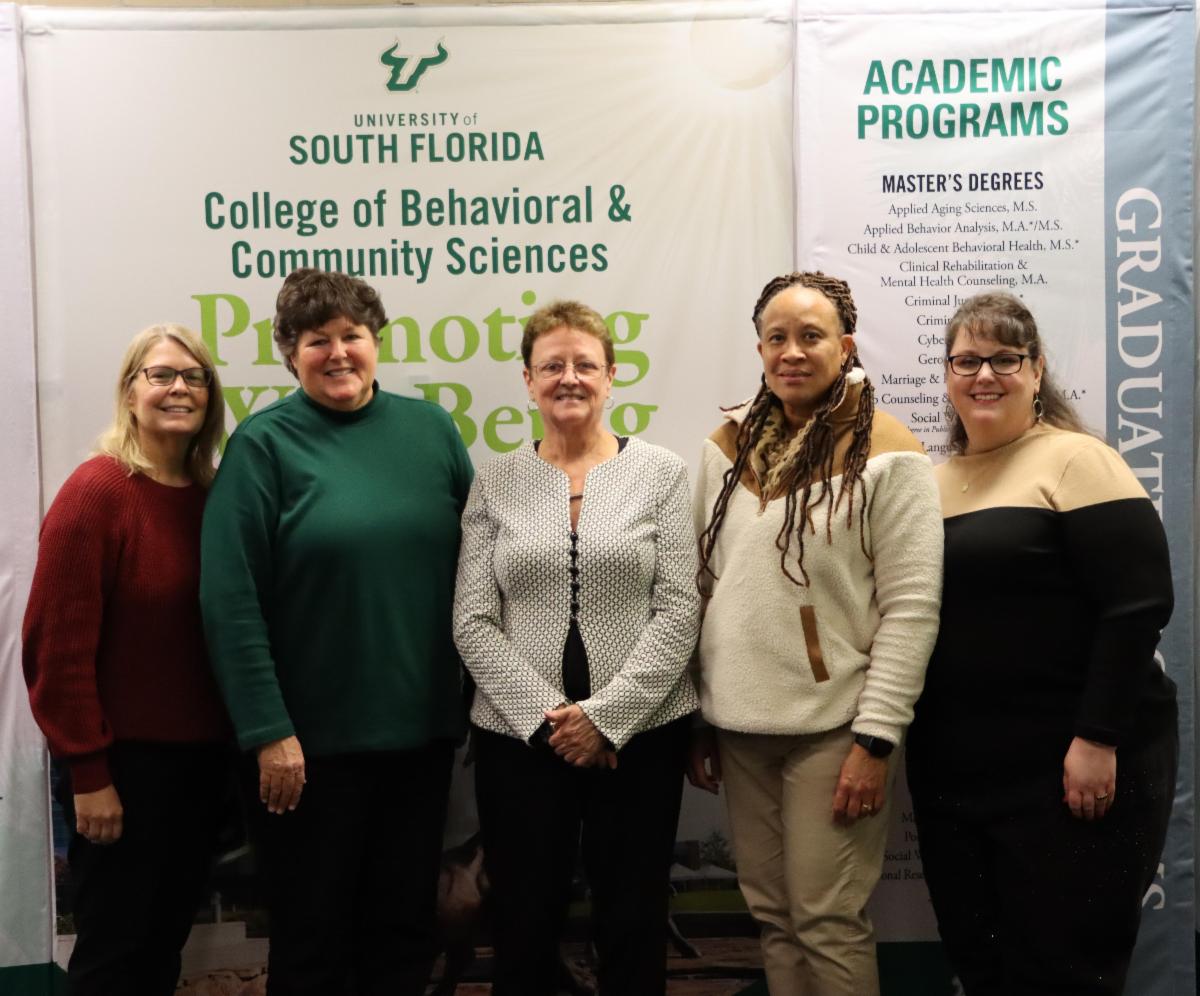 Photo of employees with the dean of college