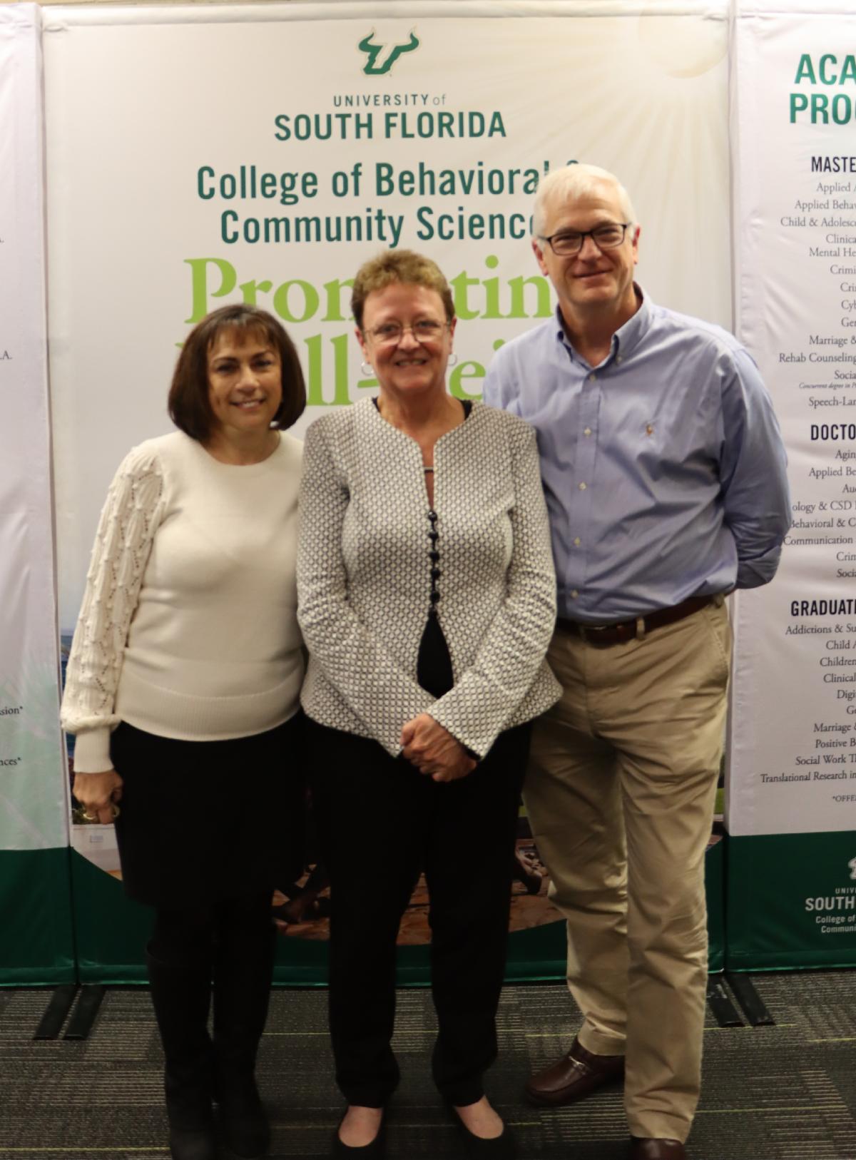 Photo of employees with the dean of college