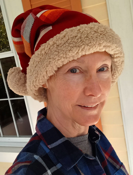 Red wool stocking cap with ribbon embellishments and cotton lining