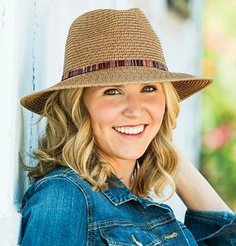 Large sized fedora style, camel colored hat with colorful band.