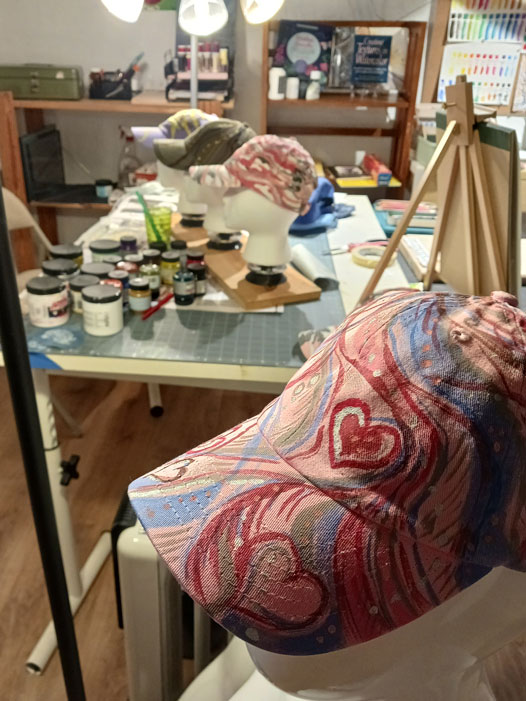 In the studio I am painting hats for Spring markets