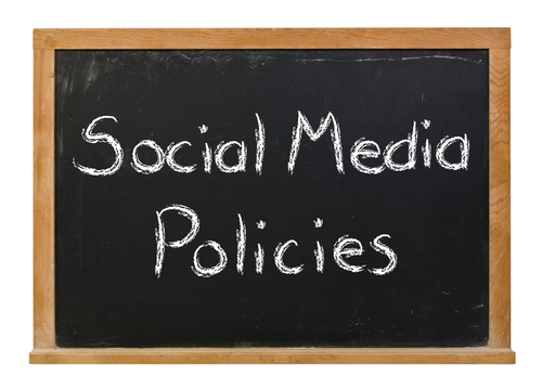 Social media policies written in white chalk on a black chalkboard isola...