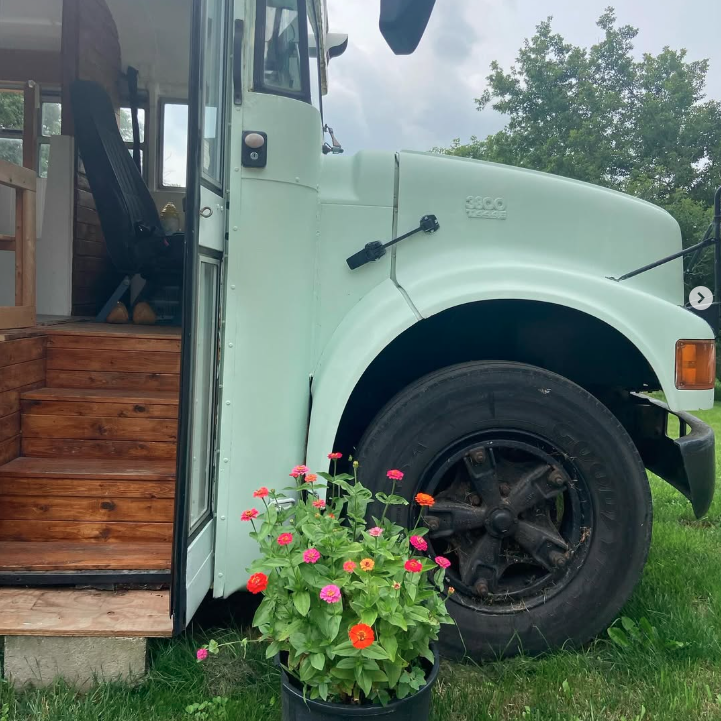 open door to a green school bus