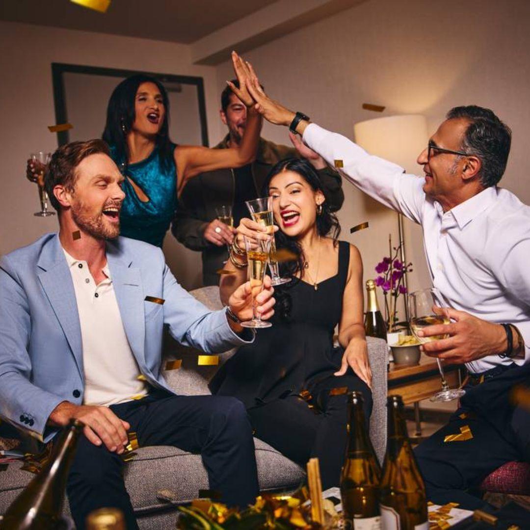 Group of people celebrating over drinks