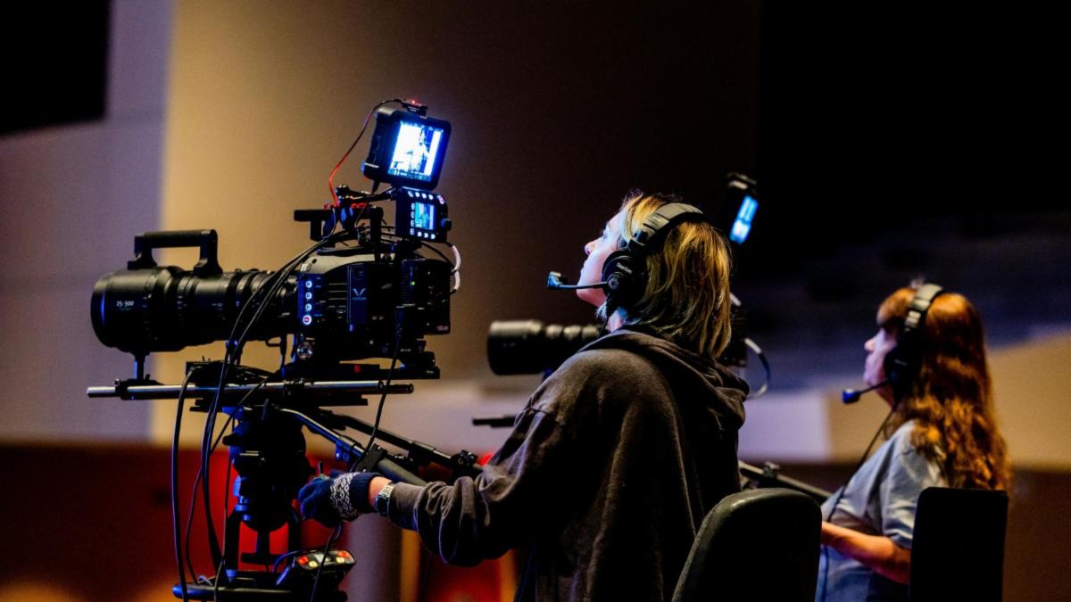 two people operating cameras