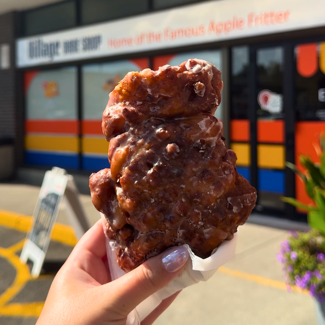 hand holding up an apple fritter
