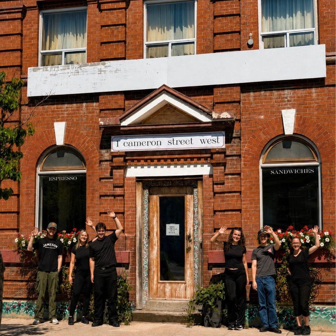 group of people cheering in front of a building