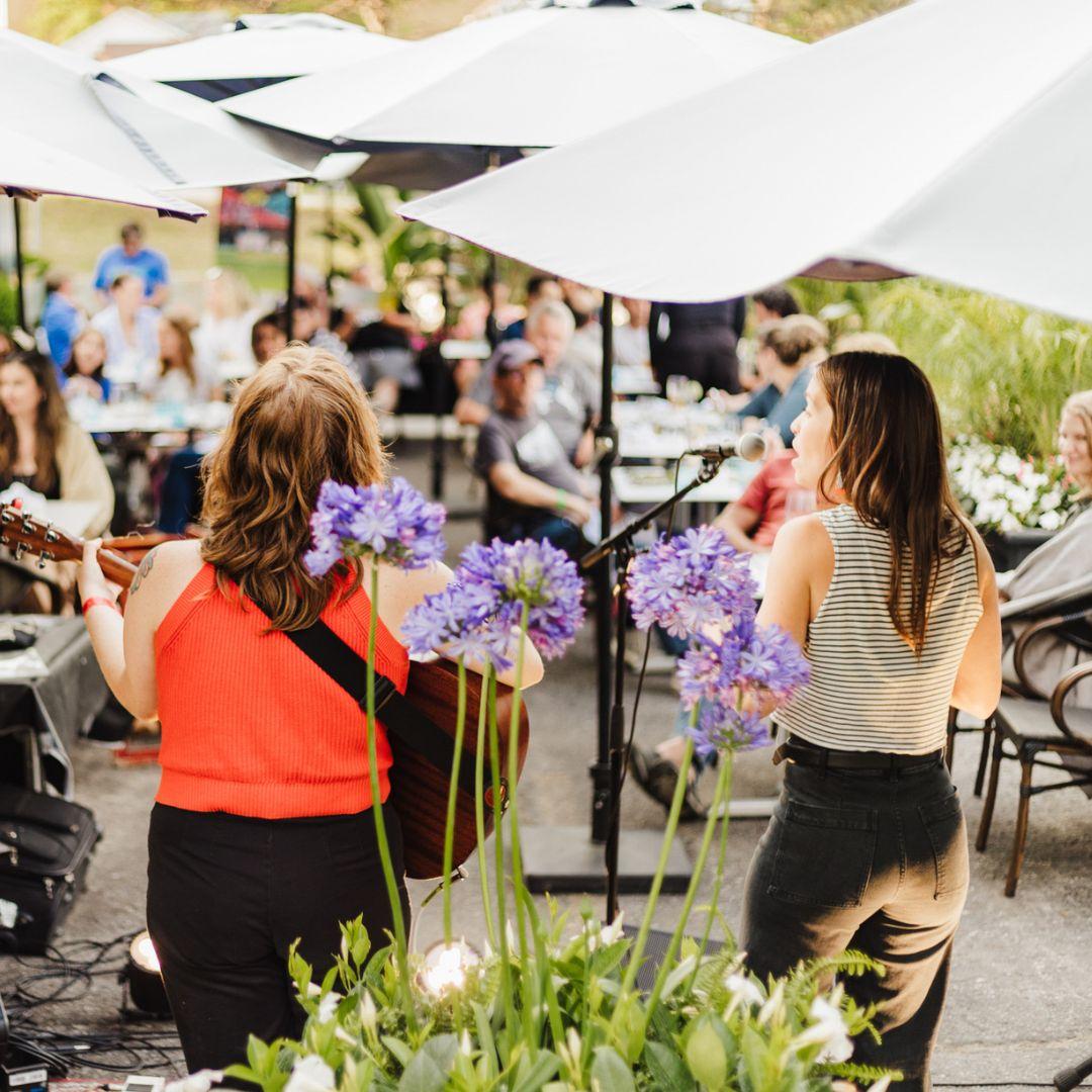 two musicians performing in outdoor space