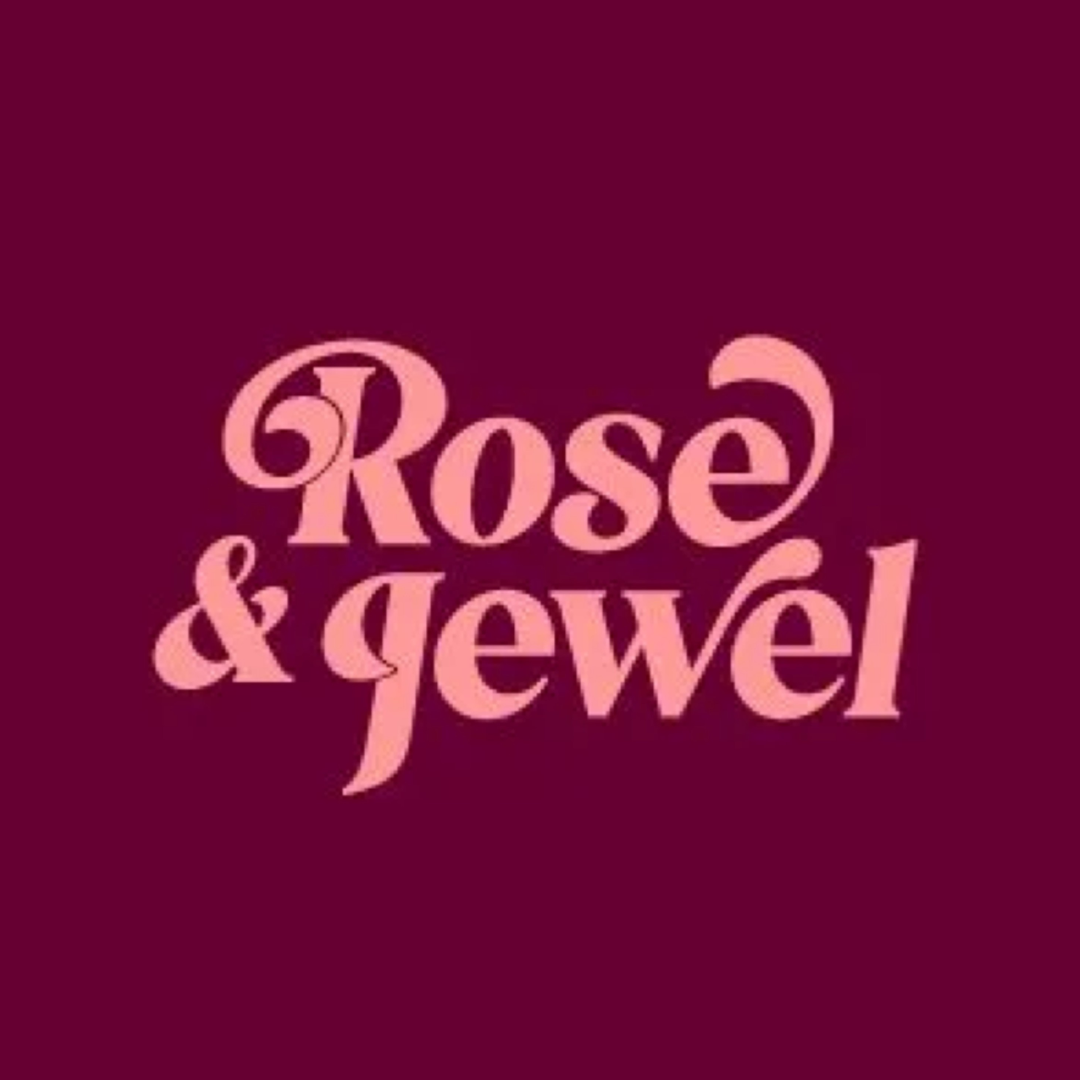 Rose and jewel in pink text on a burgundy background