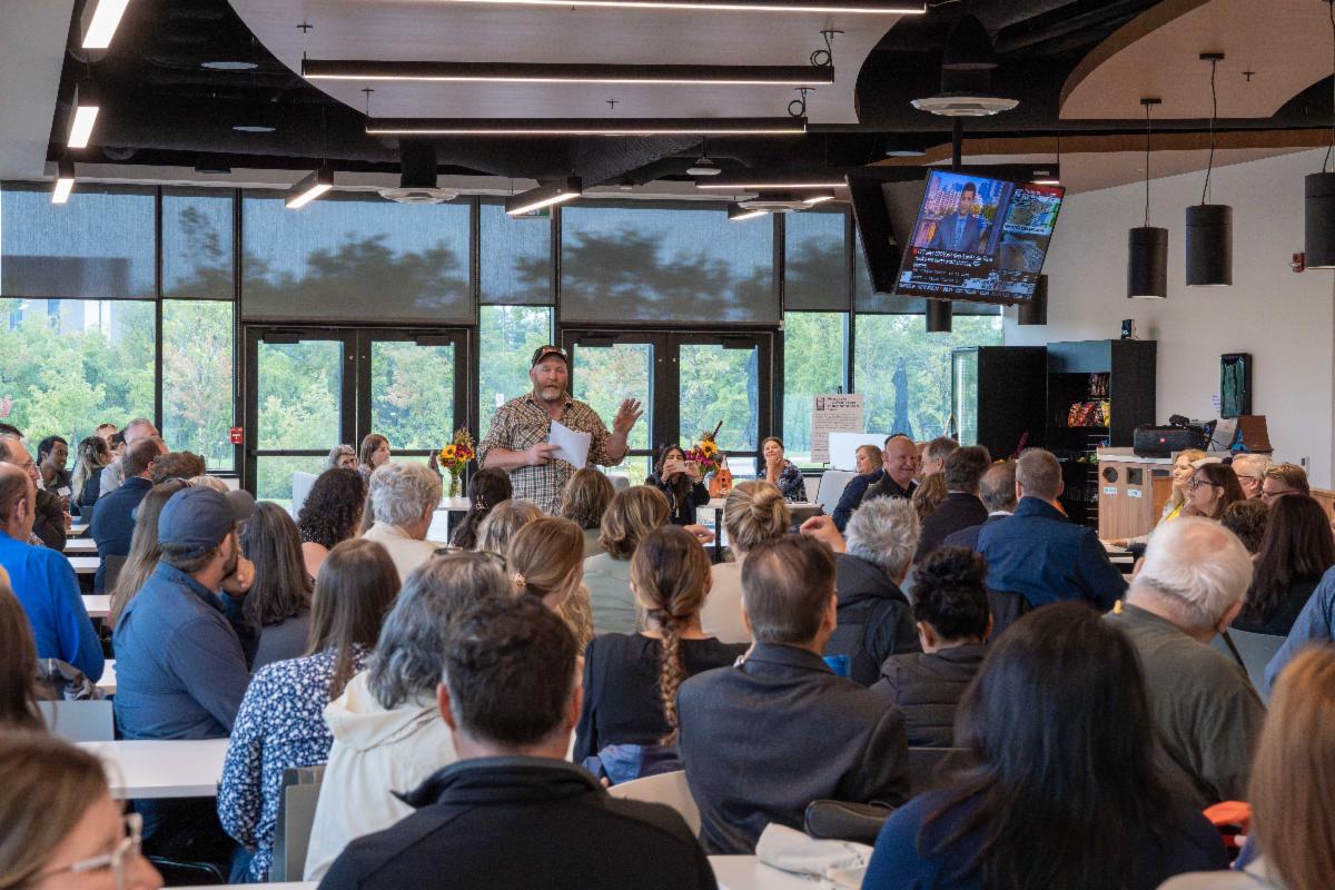 group of people listening to a speech