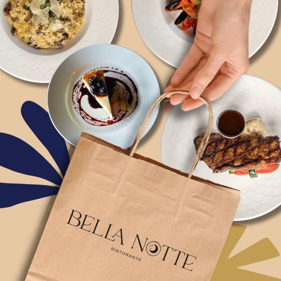 paper bag with Bella Notte written on front on table with plates of food
