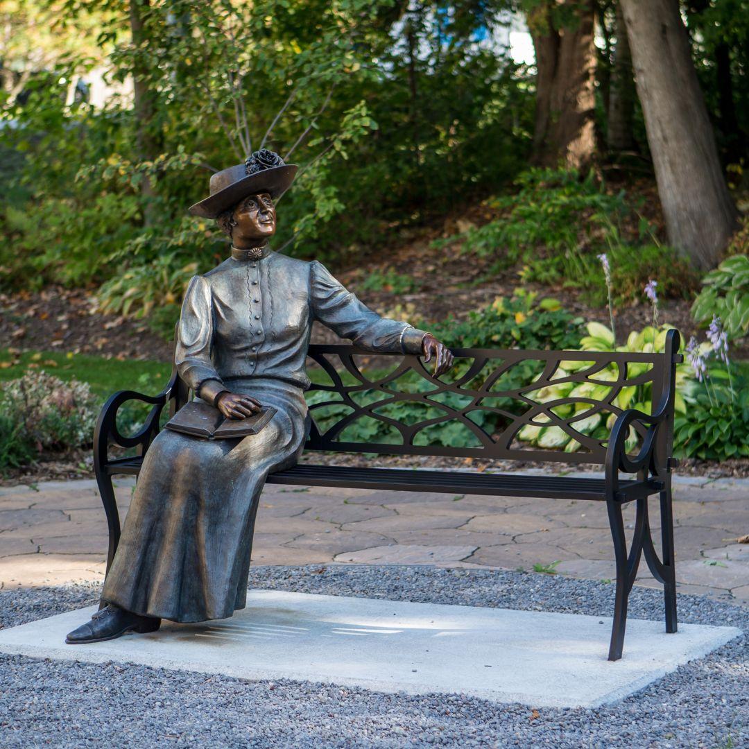 outdoor bench with bronze statue of Lucy Maud Montgomery