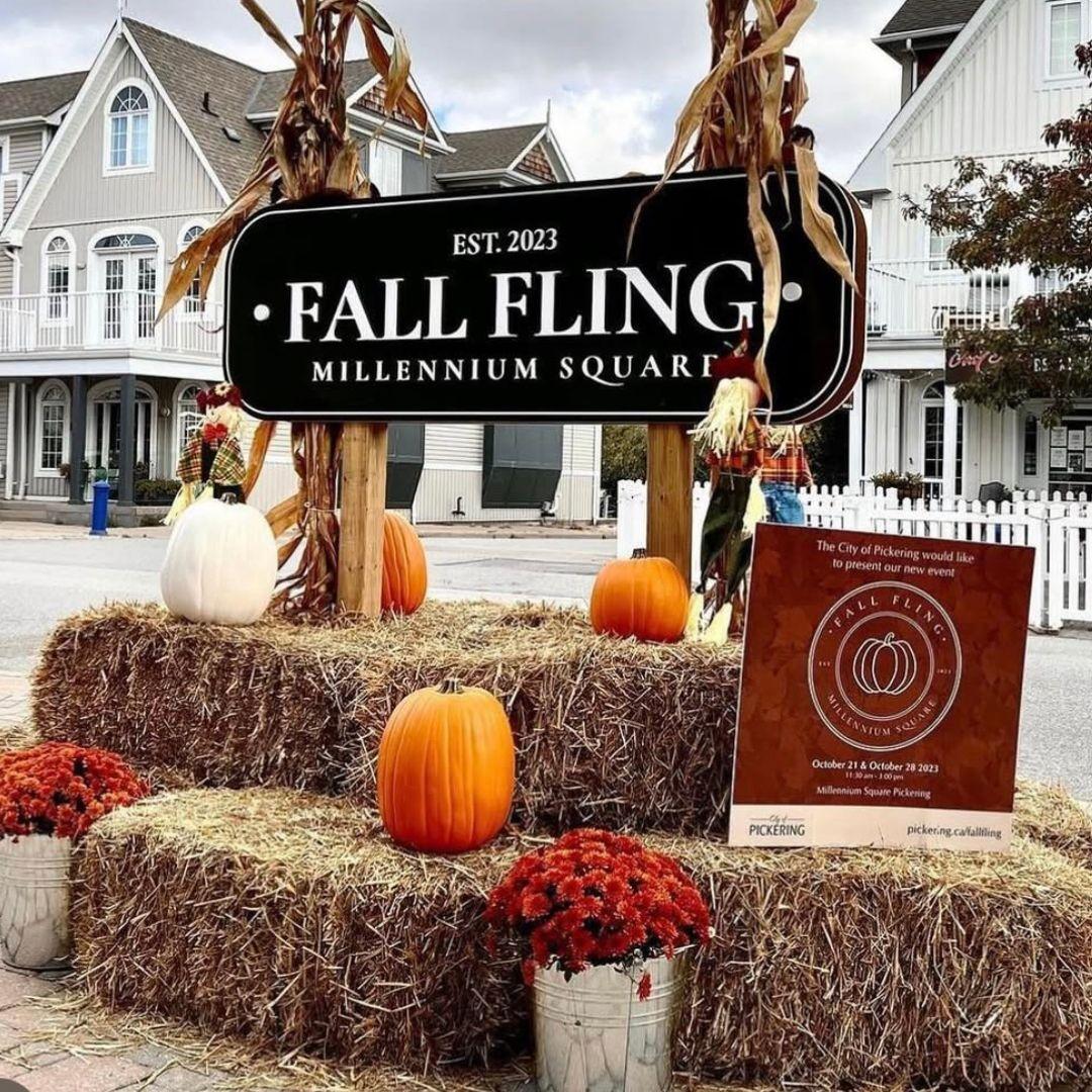 outdoor display of hay bales and pumpkins with sign that reads Fall Fling