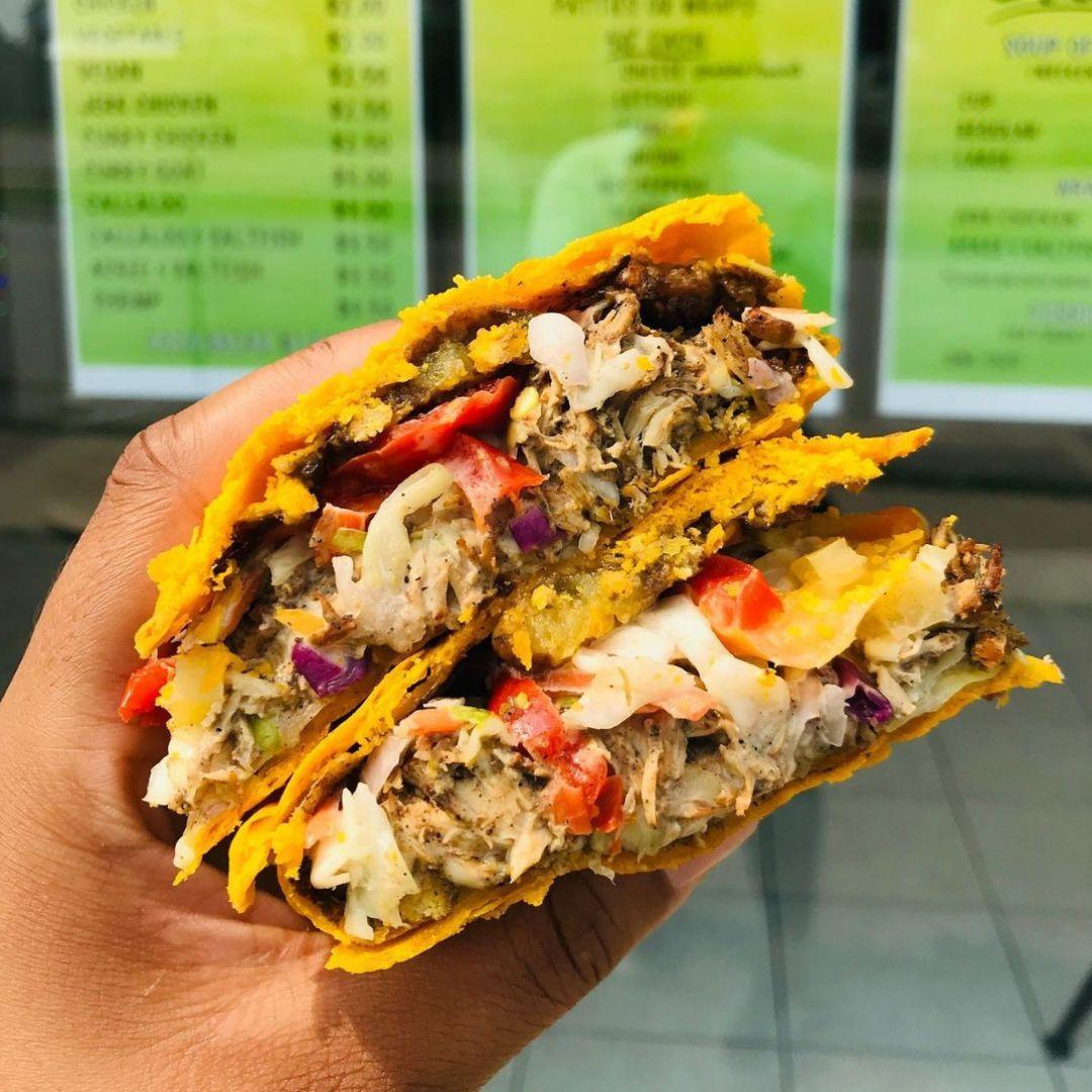 Hand holds Jamaican patty