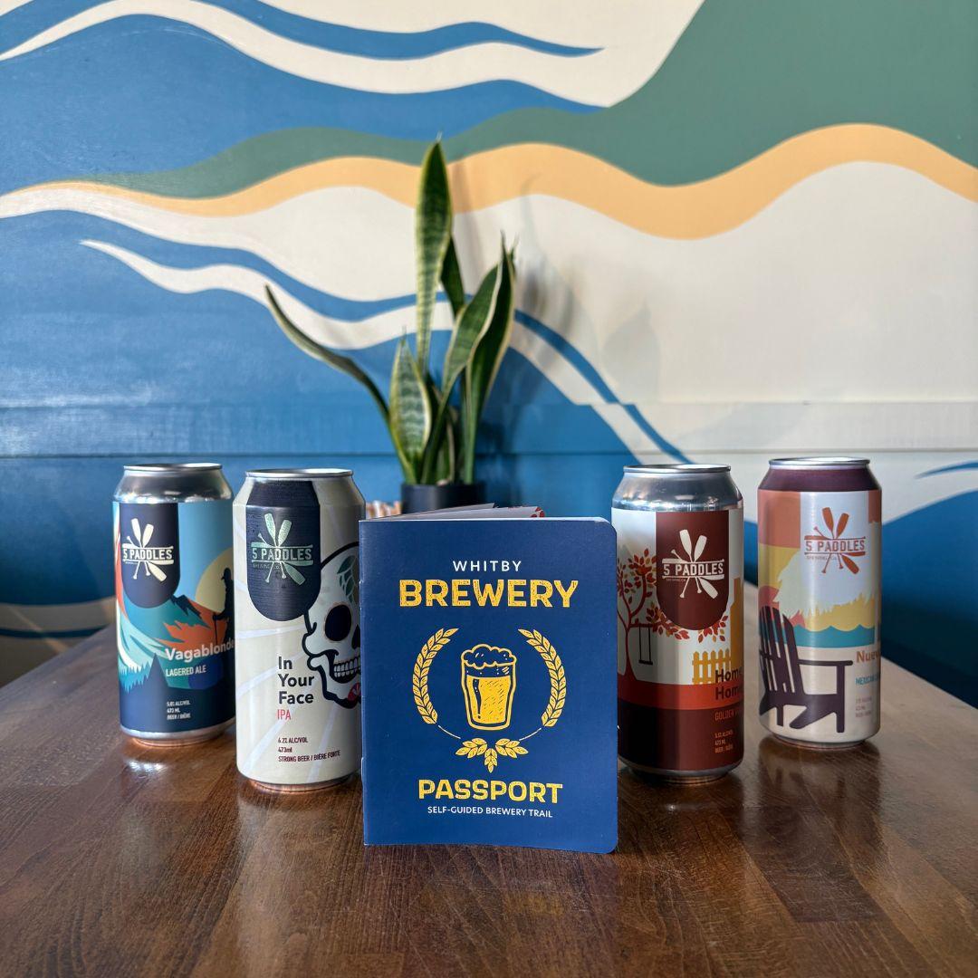 Whitby brewery passport on a table with four cans of beer