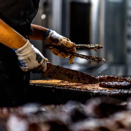 ribs being cooked over a grill