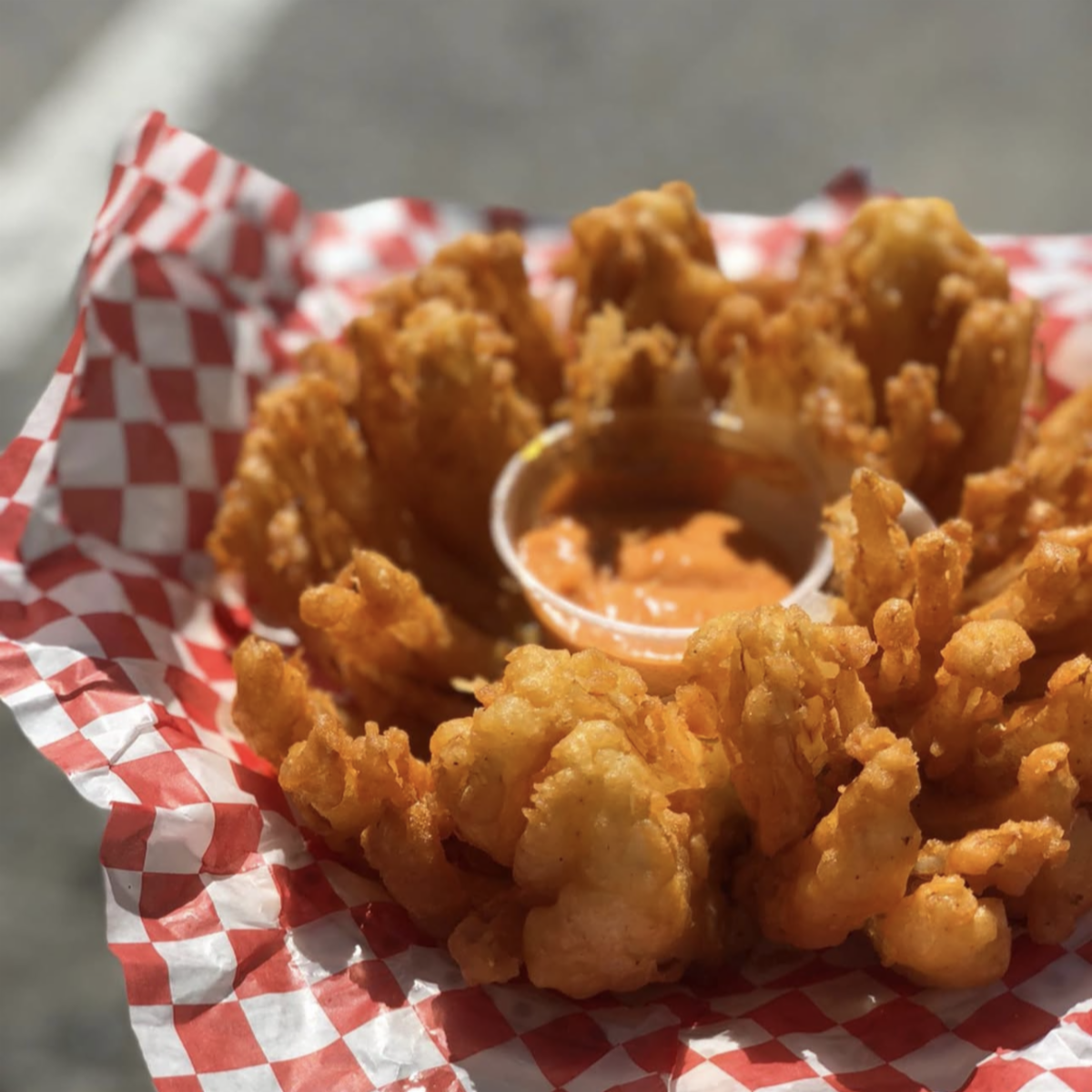 plate with a blooming onion and sauce