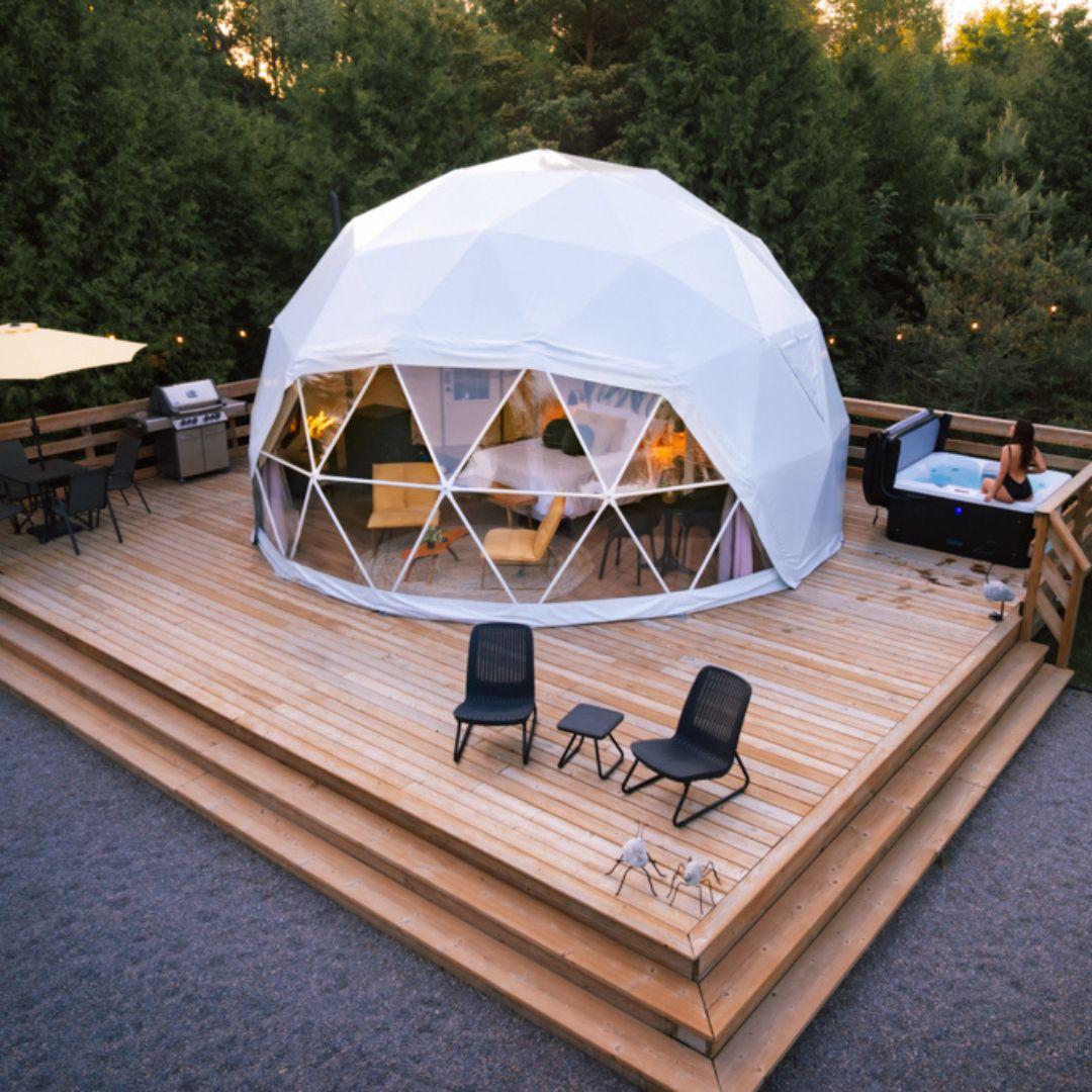 a geodisic camping dome in a forest