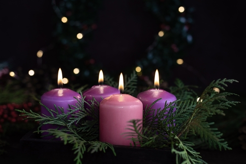 Three purple and one pink advent candles in Christmas eve_ catholic symbol.