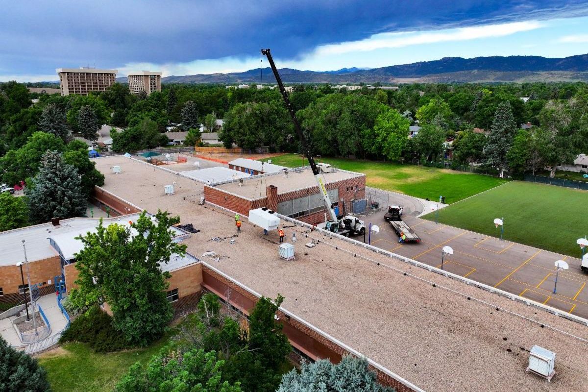 An aerial view of Dunn Elementary's roof getting an HVAC unit installed.