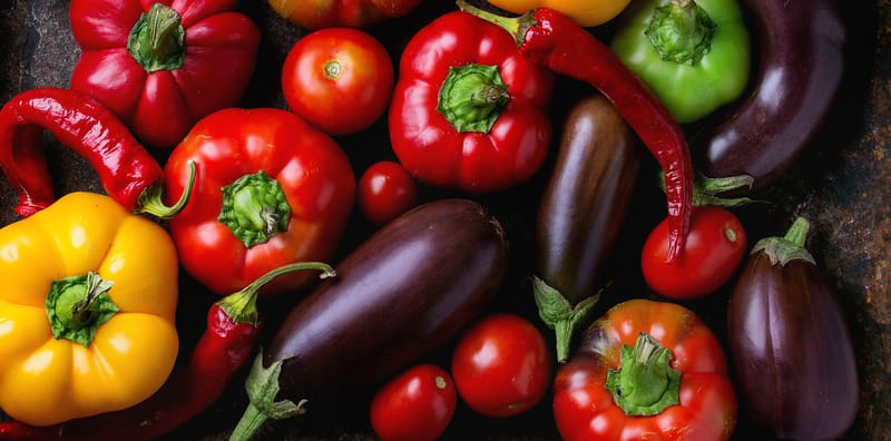 Photo of eggplants, peppers and tomatoes