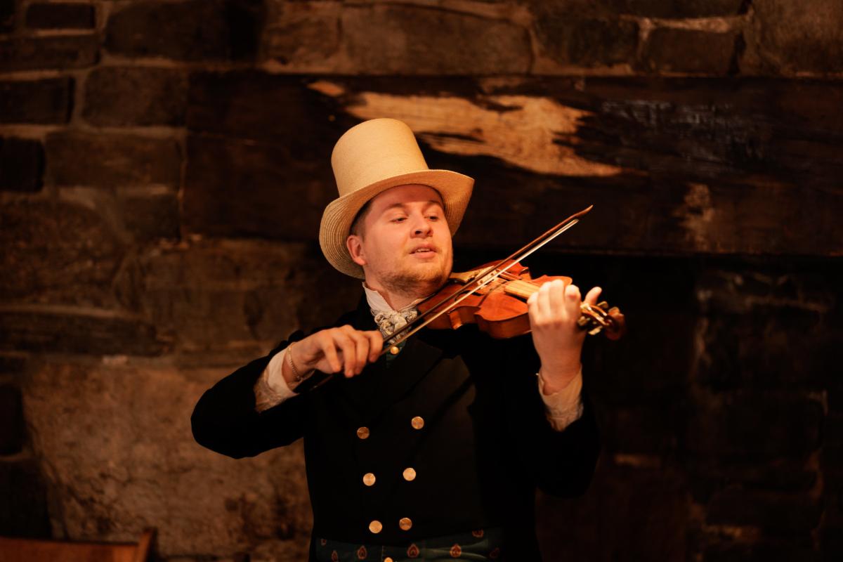 Musician performing in Bullard Tavern