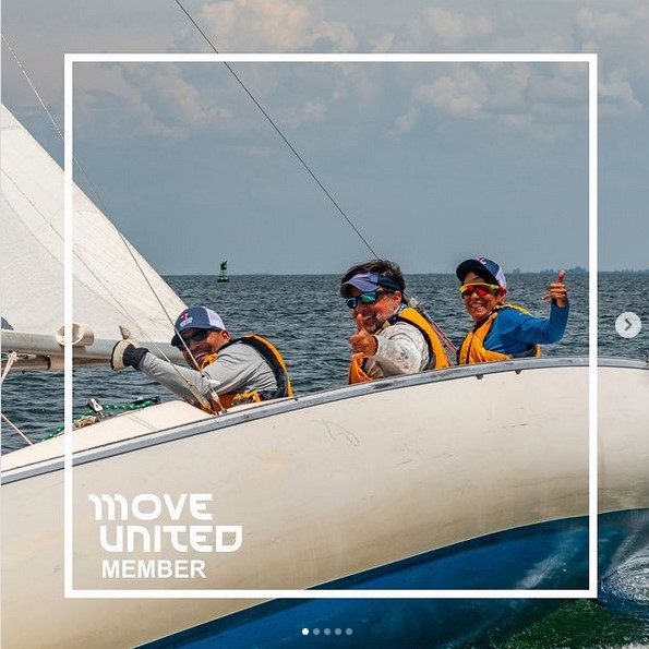 Three sailors from Warrior Sailing in a boat on the water