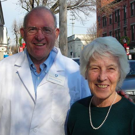 Man and woman standing outside, smiling